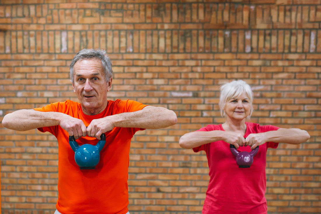 An elderly couple in the gym working with weights to keep their body in shape.